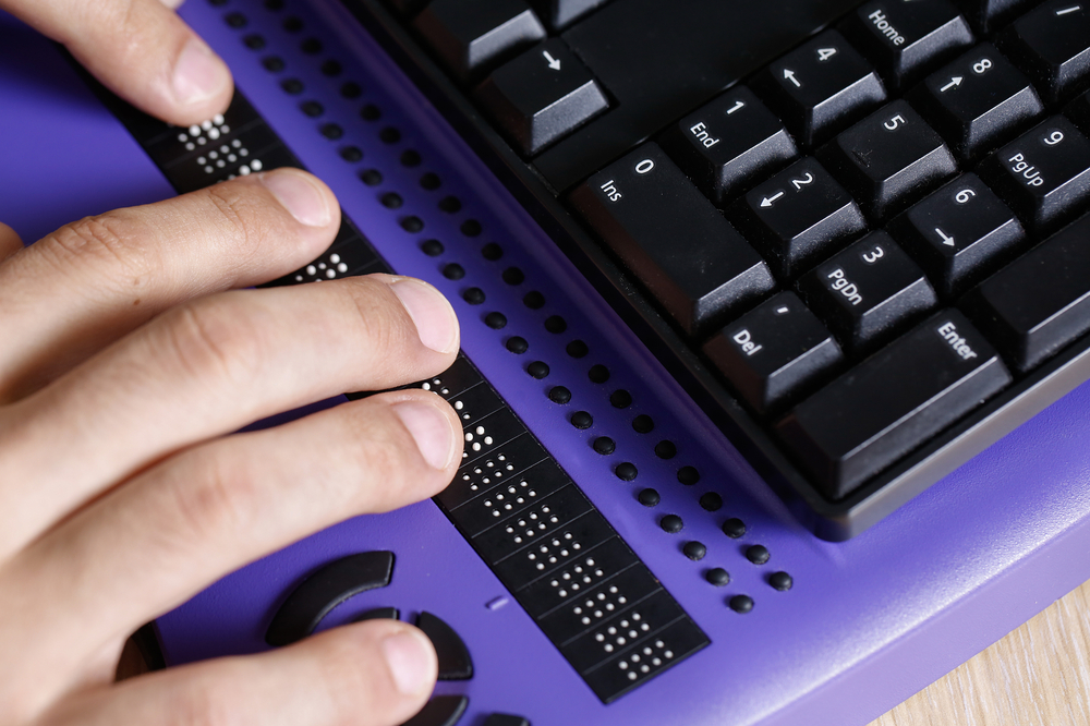 Pictured - a using a braille keyboard